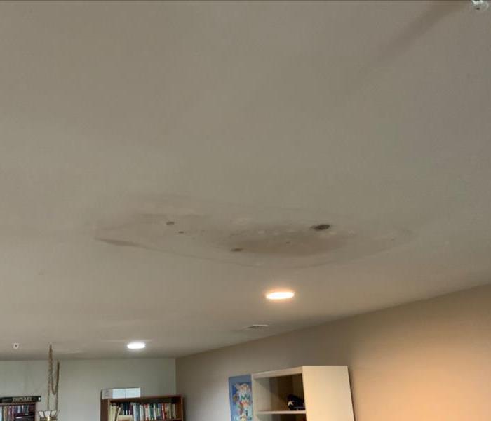 damaged white ceiling in basement of home