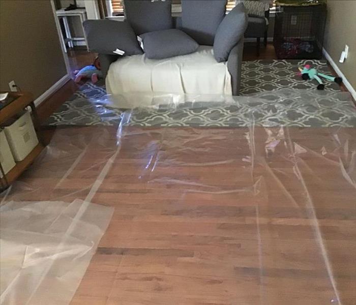 wooden flooring in home covered in plastic