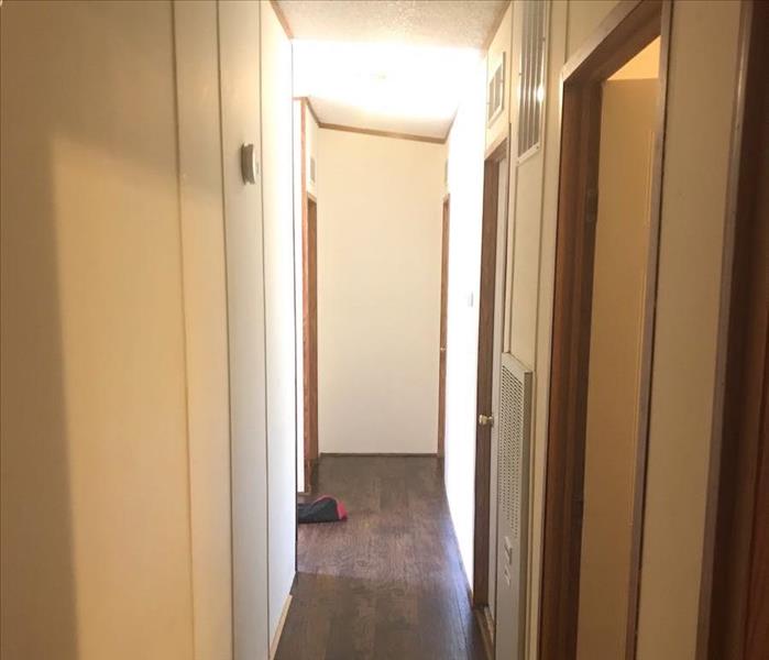 Hallway with wooden floor and white walls