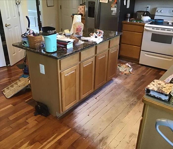 Kitchen with water damaged floors and eqiupment