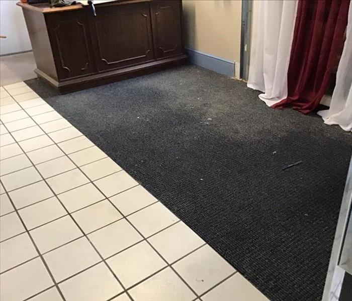 water flooded tile and carpet flooring in office building