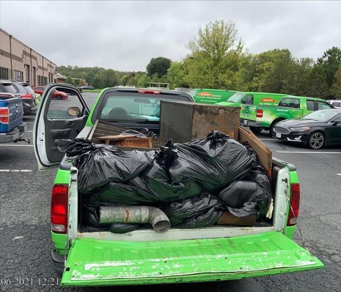 truck rear filled with trash out after storm hit