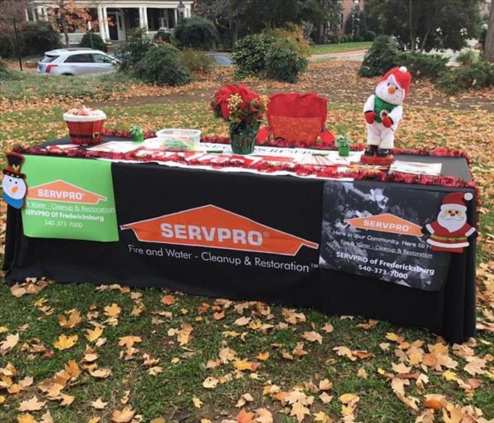 Marketing table set up outdoors for SERVPRO of Fredericksburg with Christmas Decore